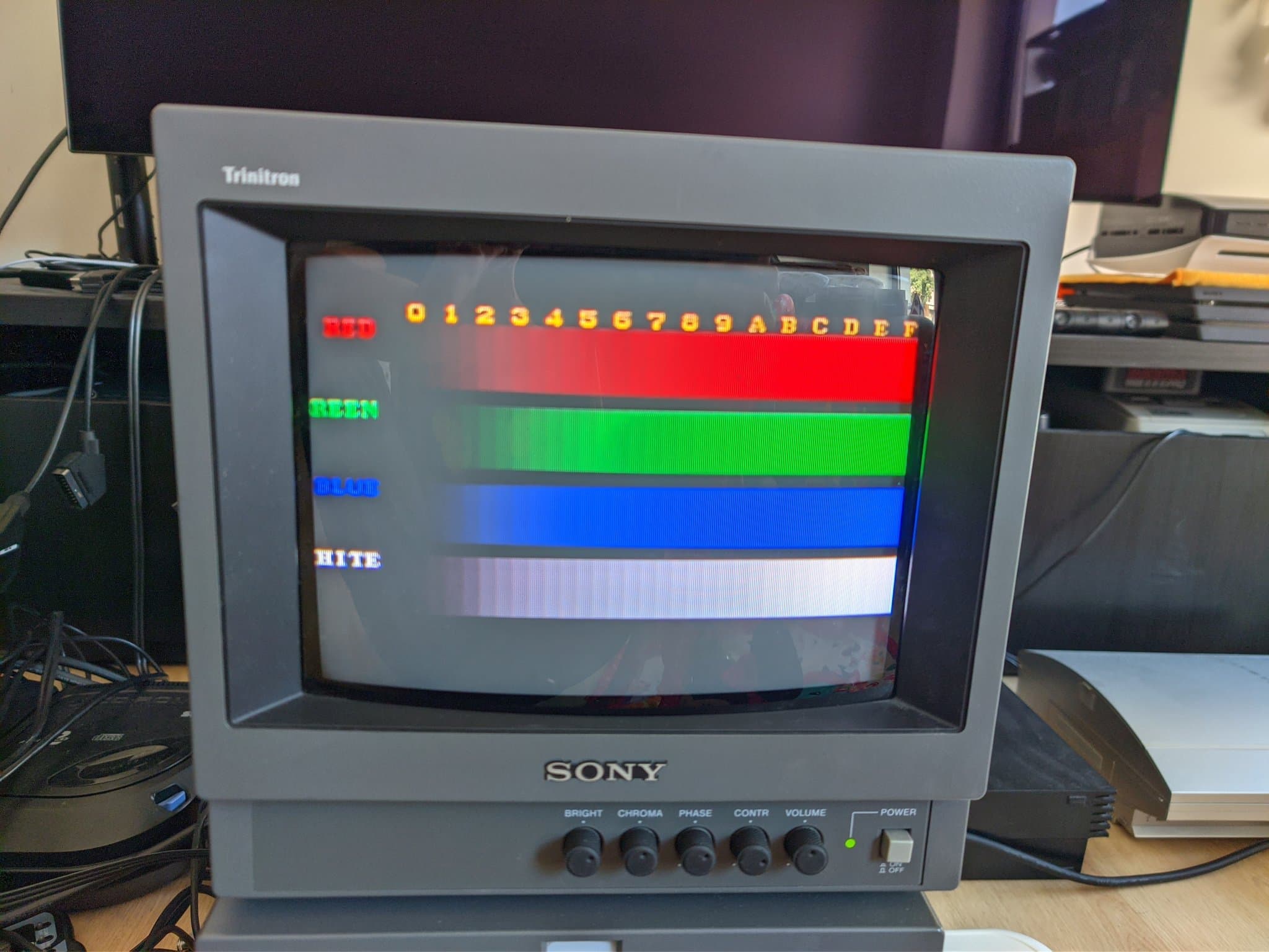 Sony PVM-9040 displaying color test pattern with red, green, blue, and white horizontal stripes showing color output issues.