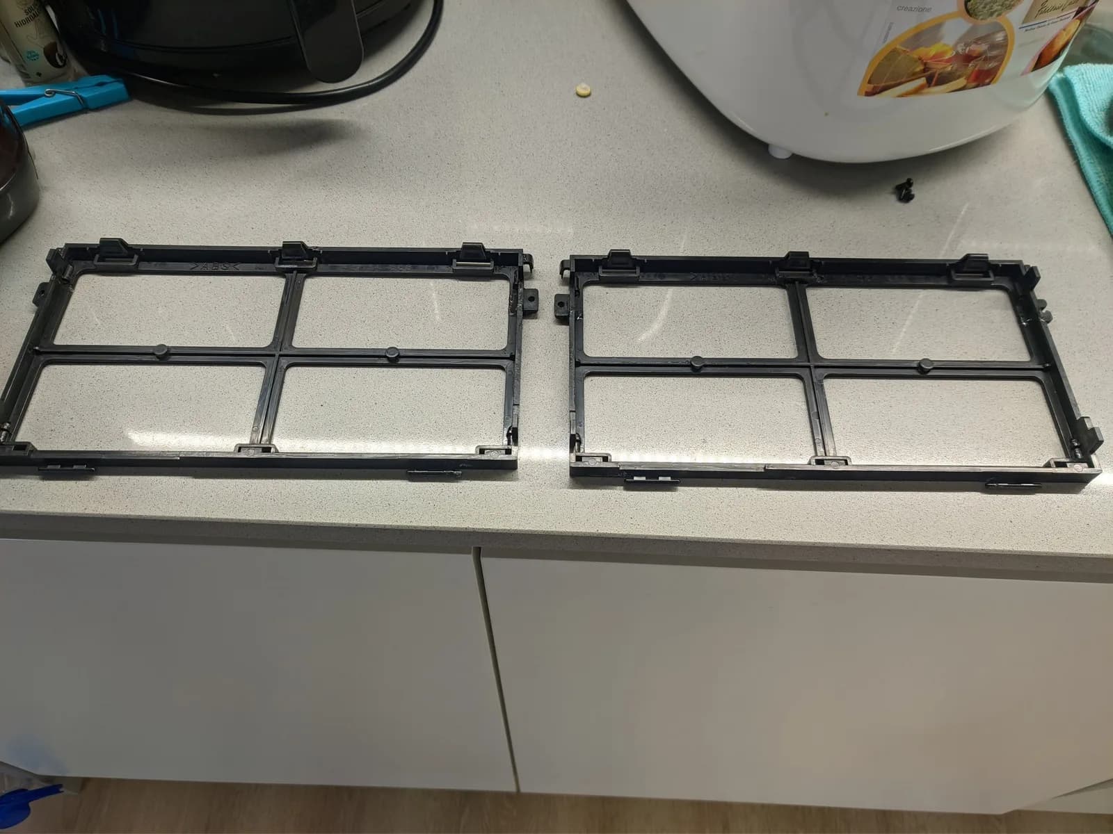 Two black plastic deflection board frames displayed side-by-side on white surface during BVM-9045QD restoration work.