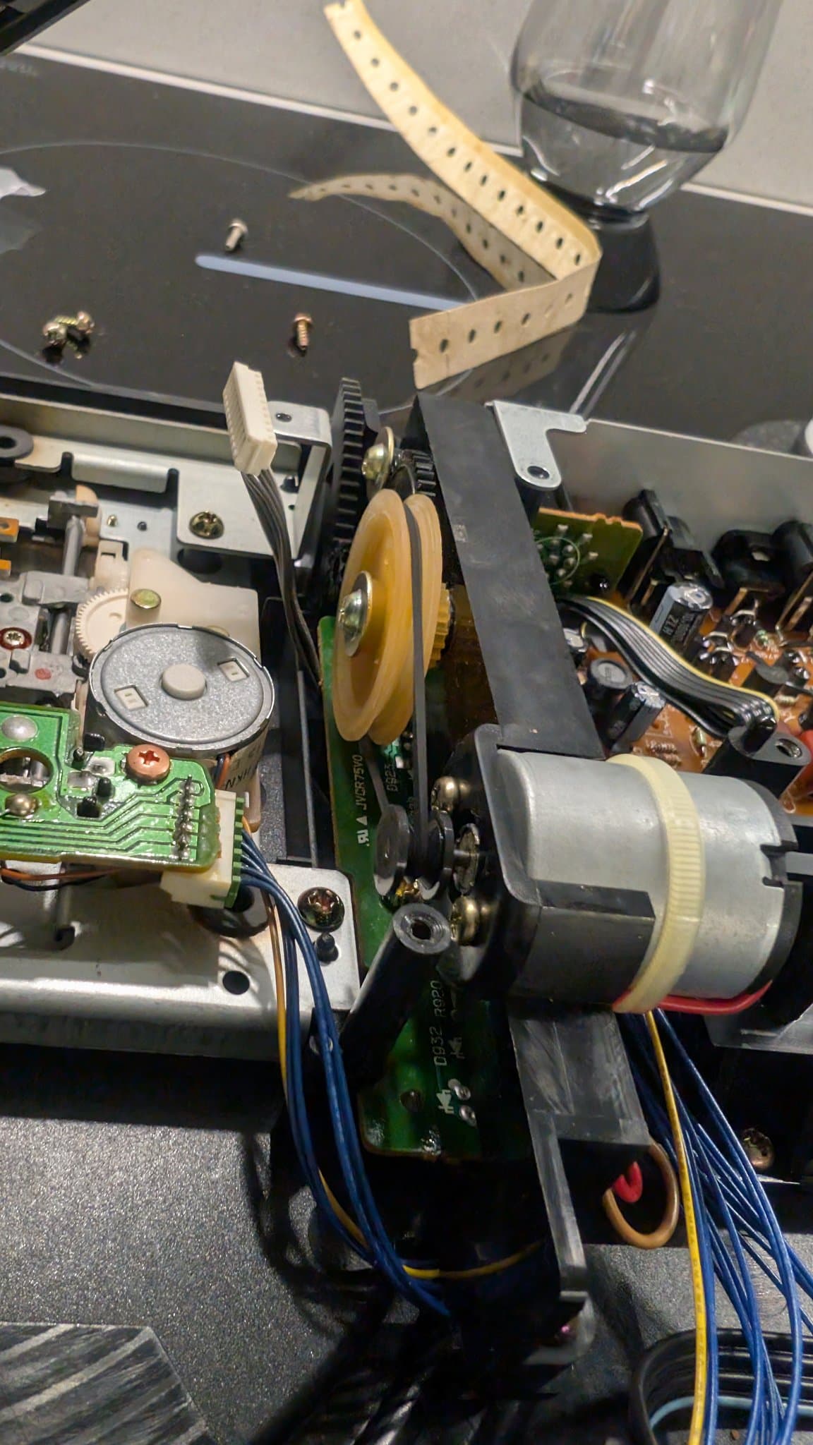 Sega Wondermega HWM-5010 open chassis showing new replacement belt installed on motor drive system and internal circuitry during repair.
