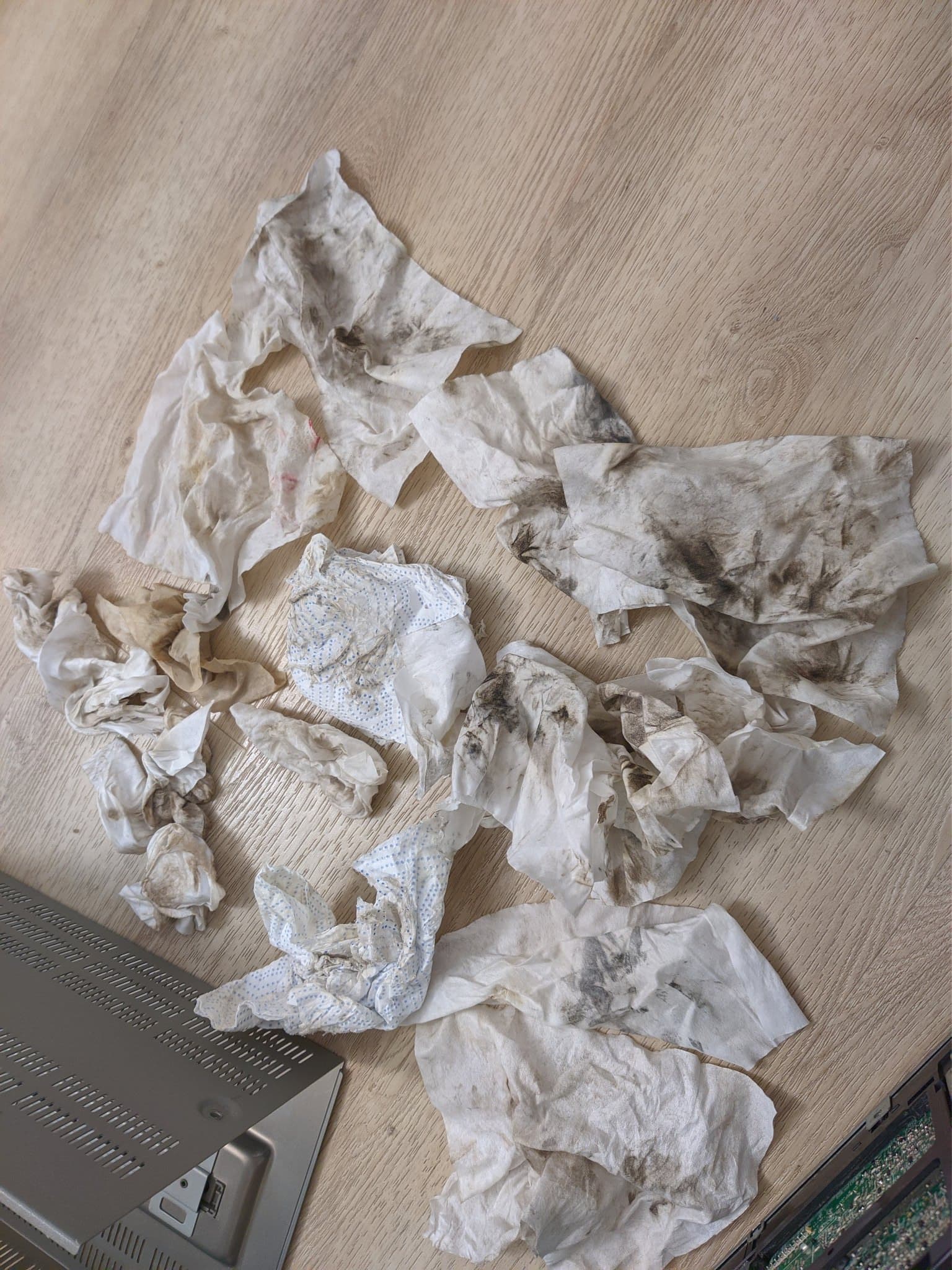 Used tissues and cleaning materials from Sony BVM-9045QD restoration, showing heavy nicotine and dust buildup removal during CRT monitor restoration process.