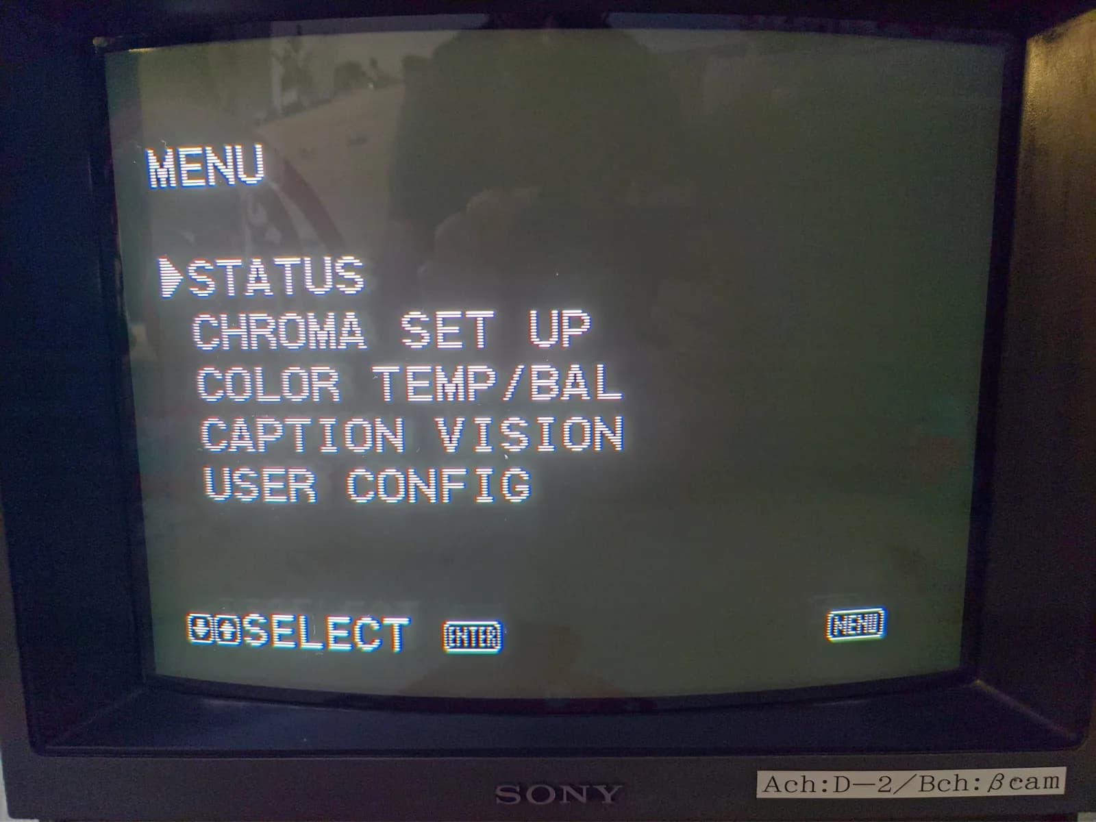 Sony PVM-14M4J menu screen showing STATUS, CHROMA SET UP, COLOR TEMP/BAL, CAPTION VISION, and USER CONFIG options during post-repair testing.