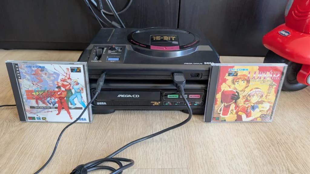 Sega Mega-CD model 1 console with Mega Drive, displaying Final Fight and Lunar game cases, ready for restoration work.