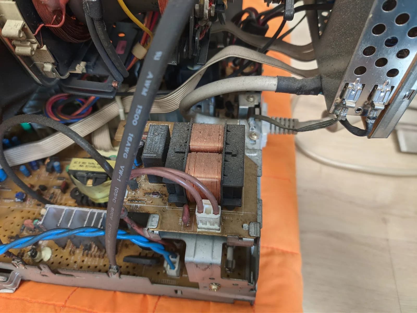 Philips 109S4 internal view showing a transformer, the copper deflection/choke coils and the circuit board with nicotine and dust residue.