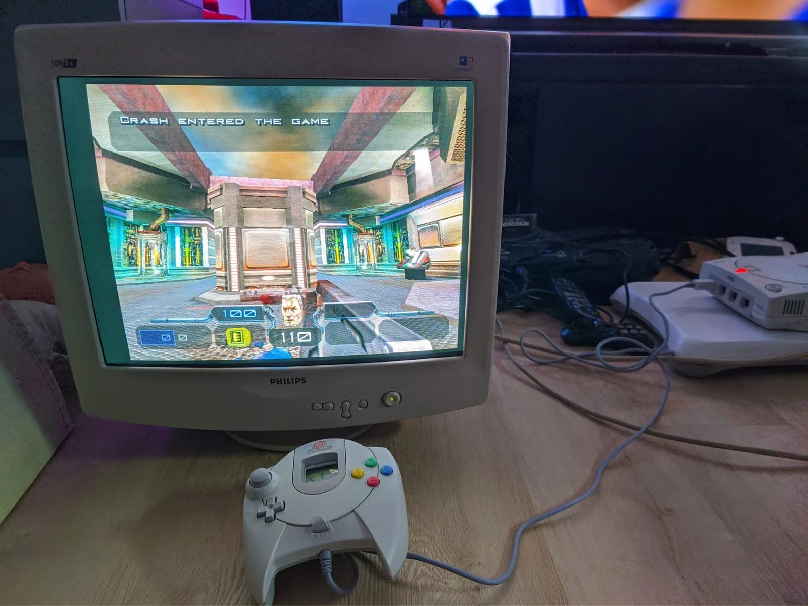 Philips 109S4 CRT running Quake III Arena from a Dreamcast (a VGA adapter is plugged into the console on the right), with a white Dreamcast controller in the foreground.