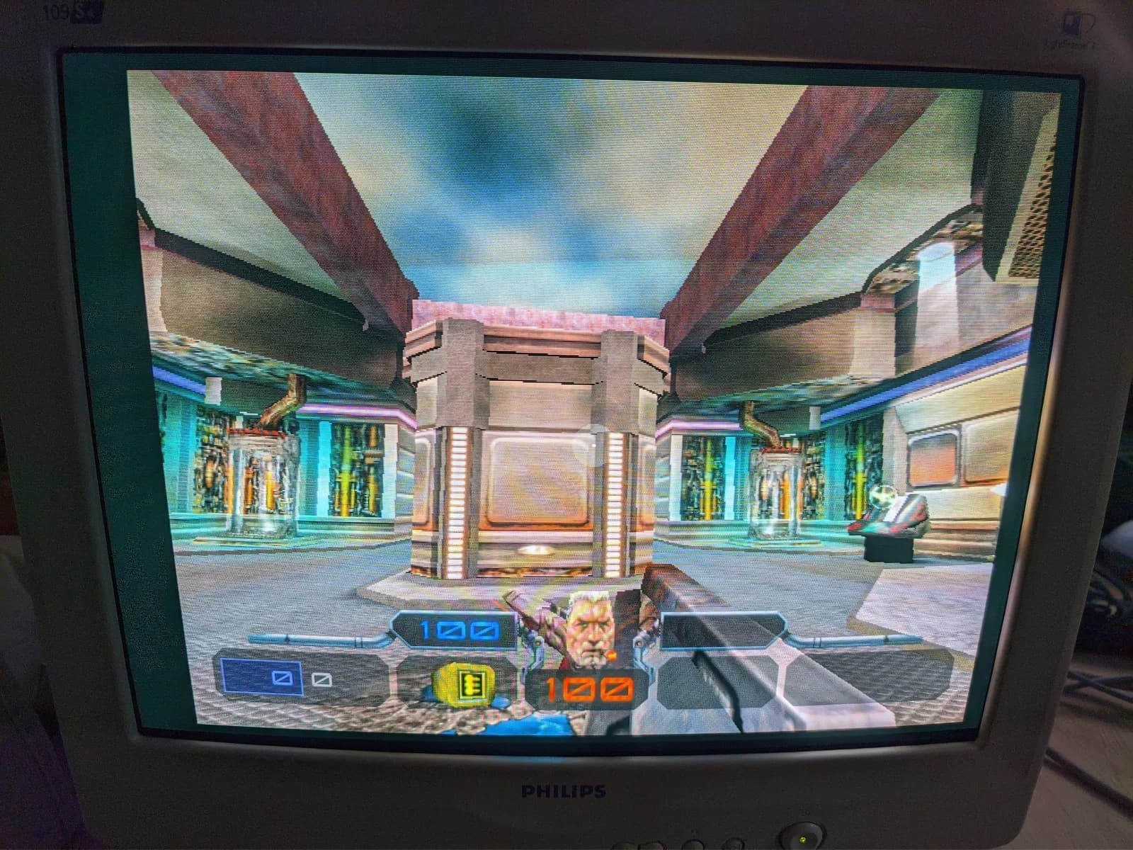 Quake III Arena running on the Philips 109S4 shadow-mask CRT, an open-air arena with the player's face and 100 health / 100 armour on the HUD.