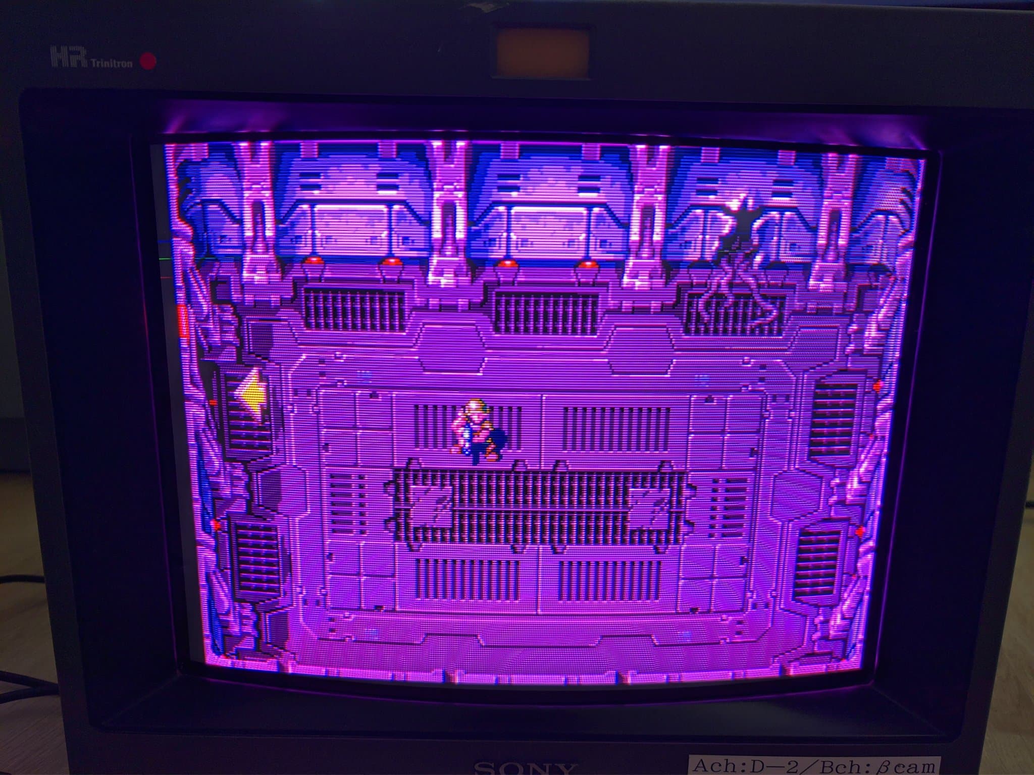 Sony PVM-14M4J displaying Metroid with prominent magenta/purple retrace lines across screen; color channel issue visible in gameplay.