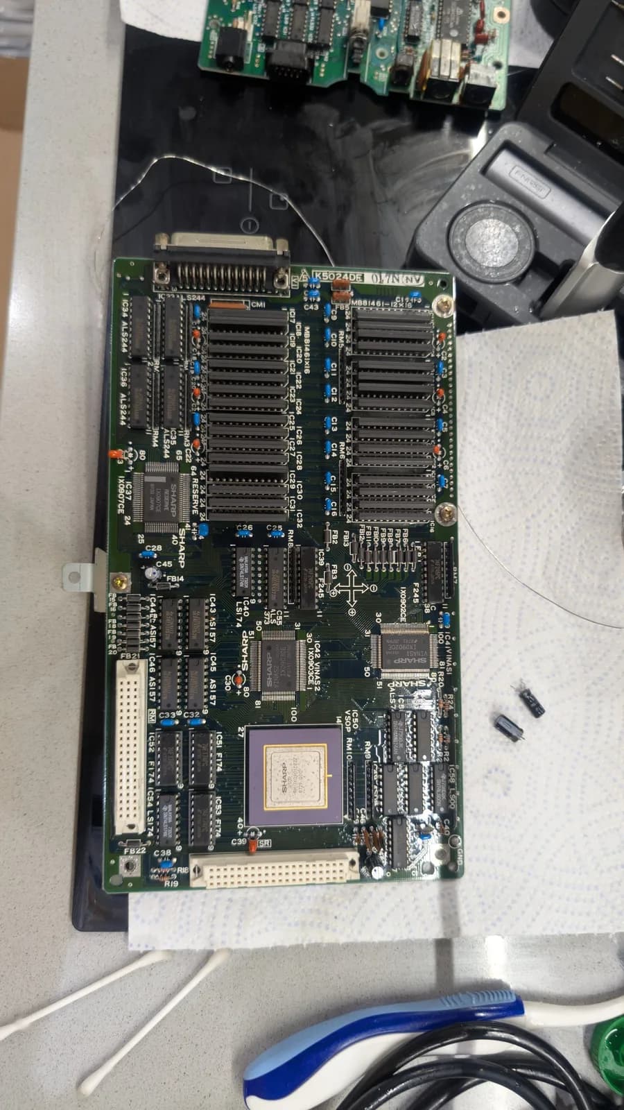 The Sharp X68000 VSOP board after being recapped and cleaned, two lonely old capacitors off to its right side.