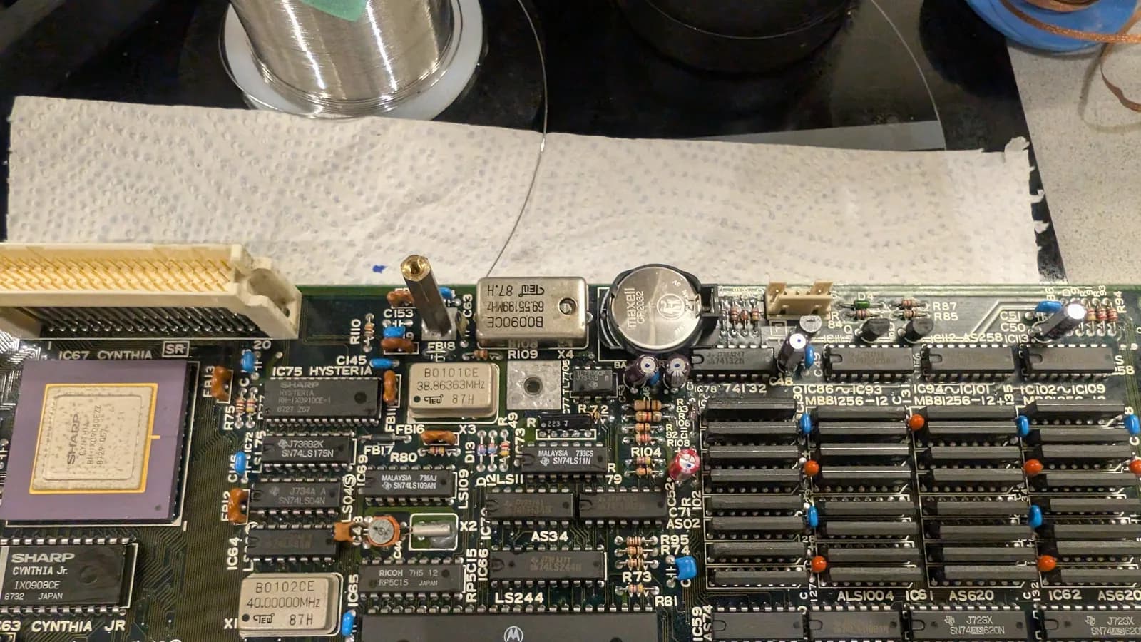 The recapped Sharp X68000 main board with the original oscillator refitted in its place and the CR2032 battery mod installed, cleaned IC sockets and solder joints.