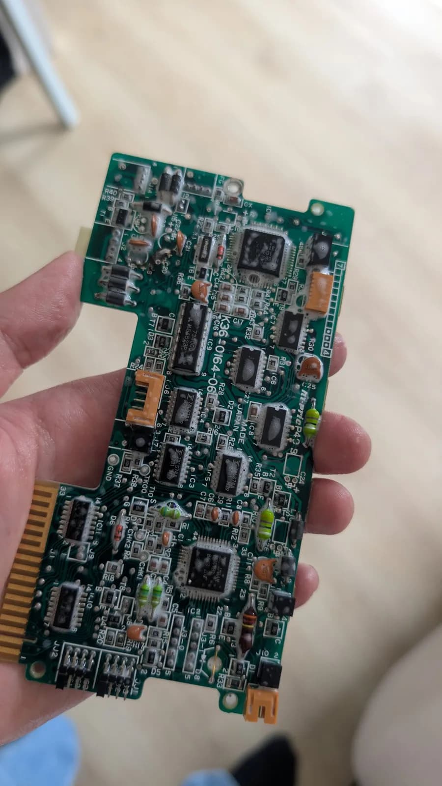 The FDD controller PCB with its capacitors removed, after an ultrasonic bath and scrub and still foamy, the broken trace not yet patched.