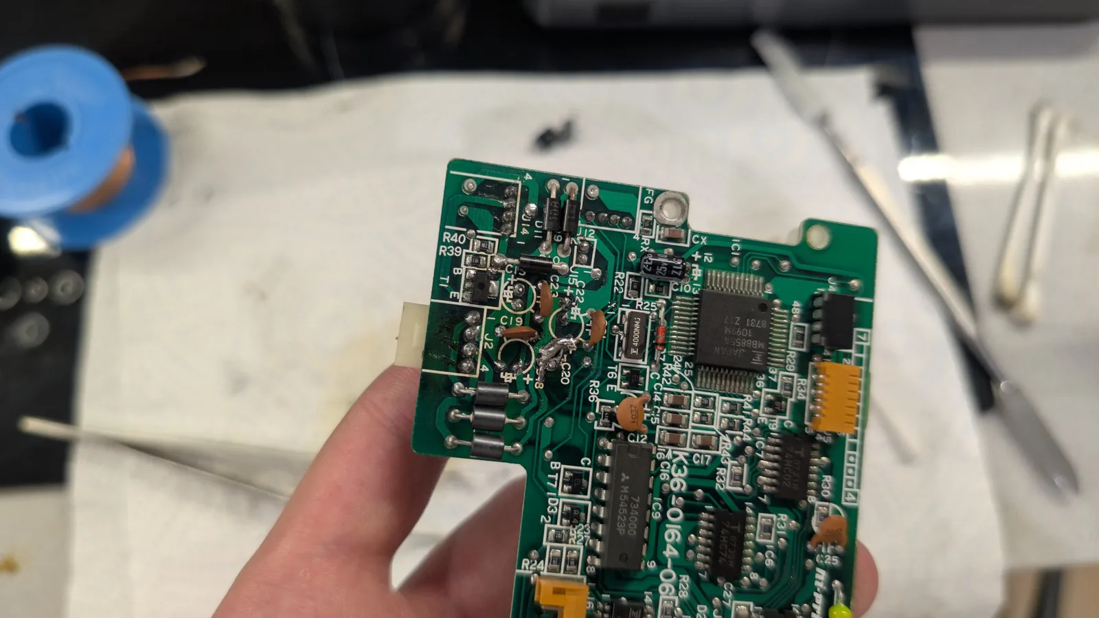 Close-up of the cleaned FDD controller PCB before its new capacitors, the trace repair clearly visible.