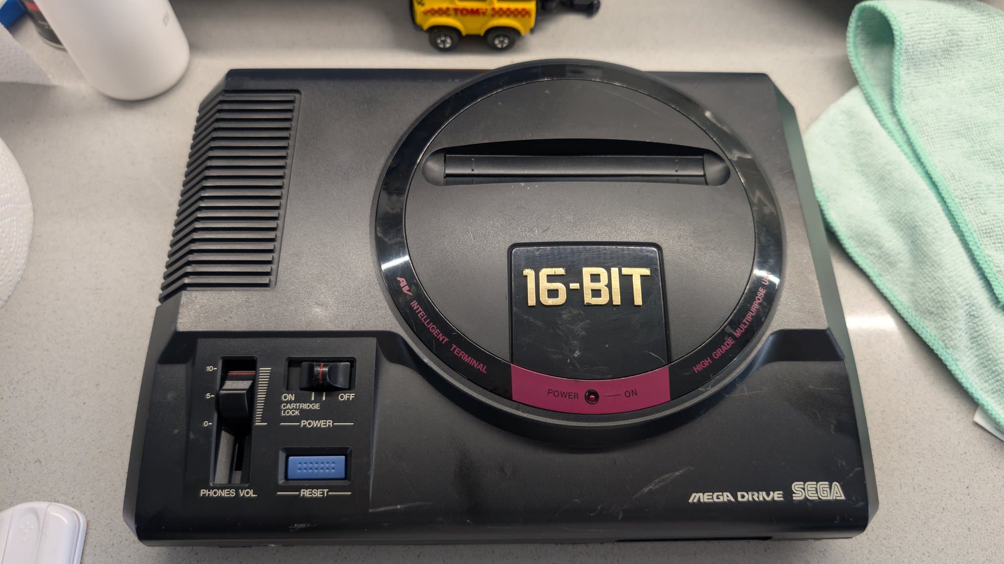 Sega Mega Drive 16-Bit console showing cleaned shell, cartridge slot, power switch, and AV connectors after recapping and restoration work.