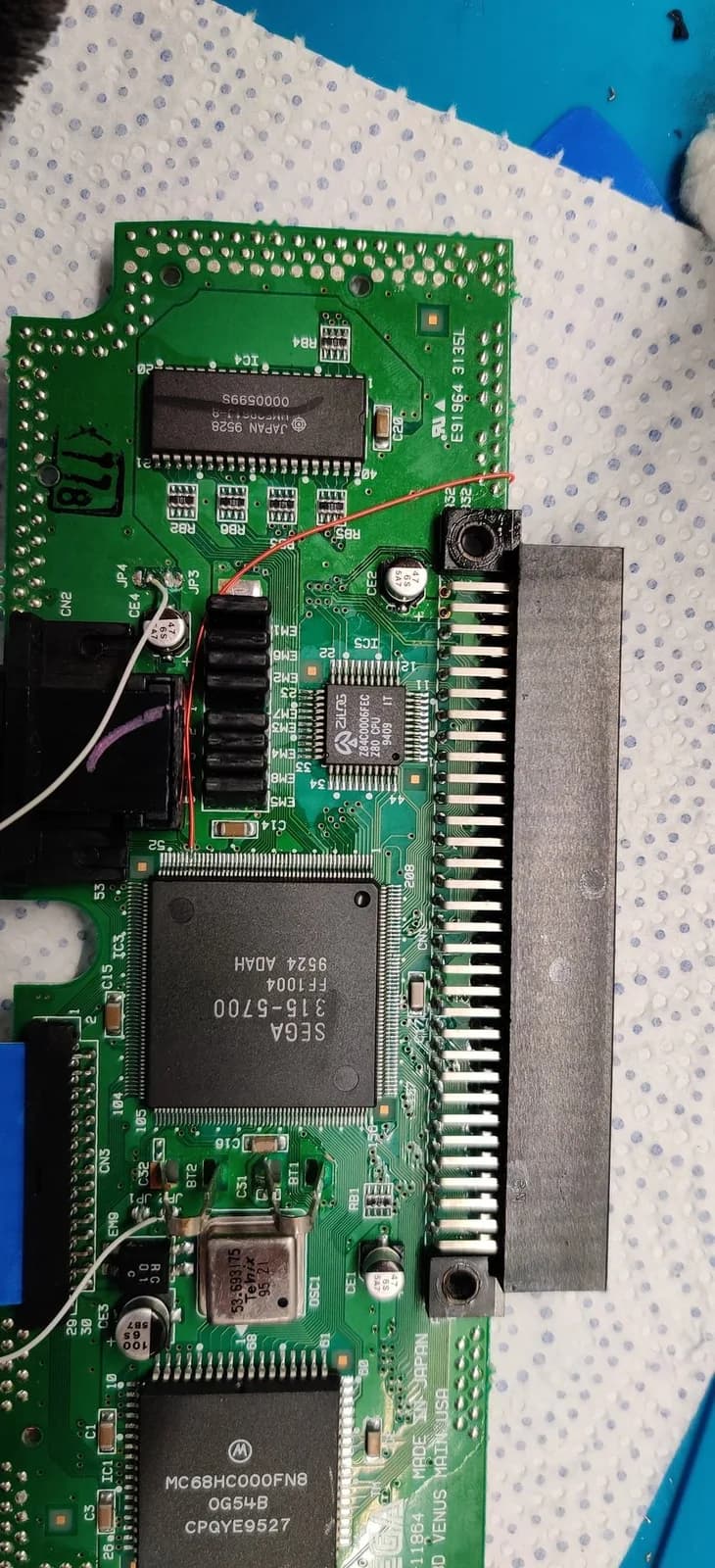 Sega Nomad mainboard with audio restoration mod: 10uF capacitors and 10k resistors soldered to audio channels for Master System/Mega-CD audio fix.