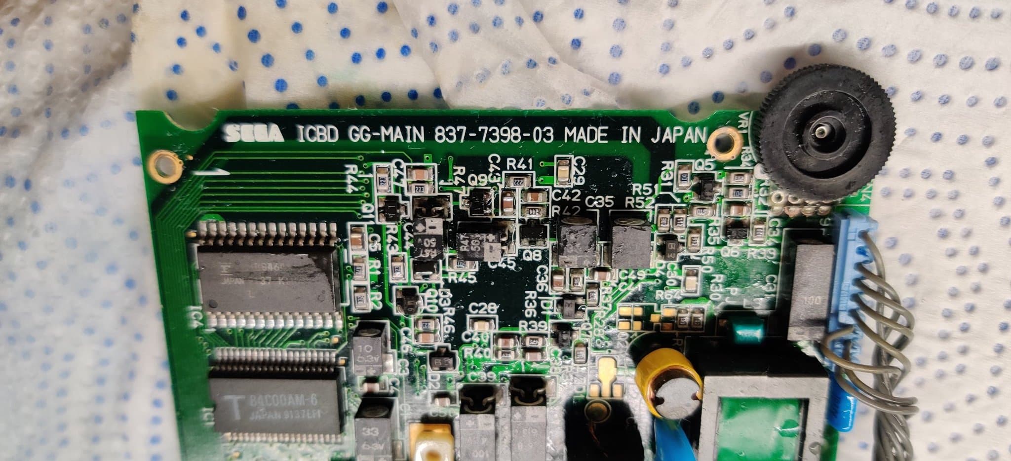 The same Game Gear board area in the next step, now cleaned of flux with Q9 refitted and the solder joints looking fresh.