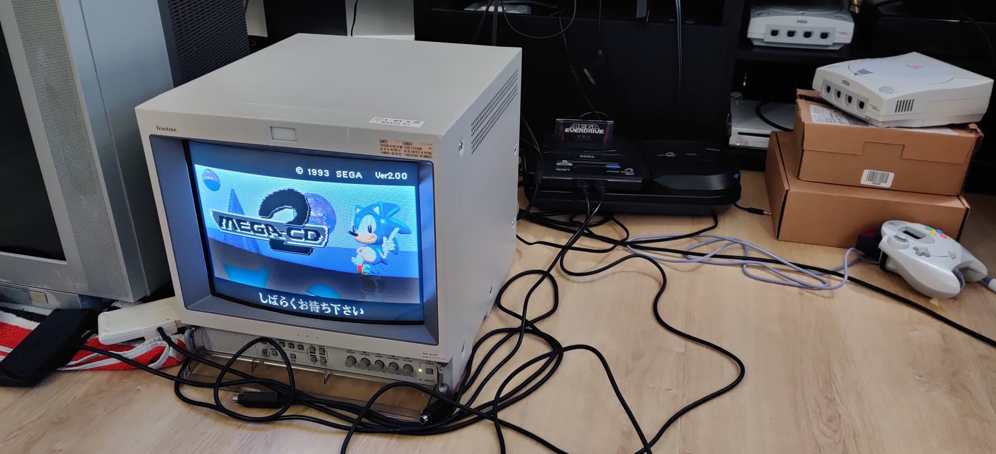 Sega Mega-CD 2 showing its BIOS boot animation, the Japanese Model 2 Mega-CD startup screen (which features Sonic), on a CRT during testing after the recap and region-free BIOS install.