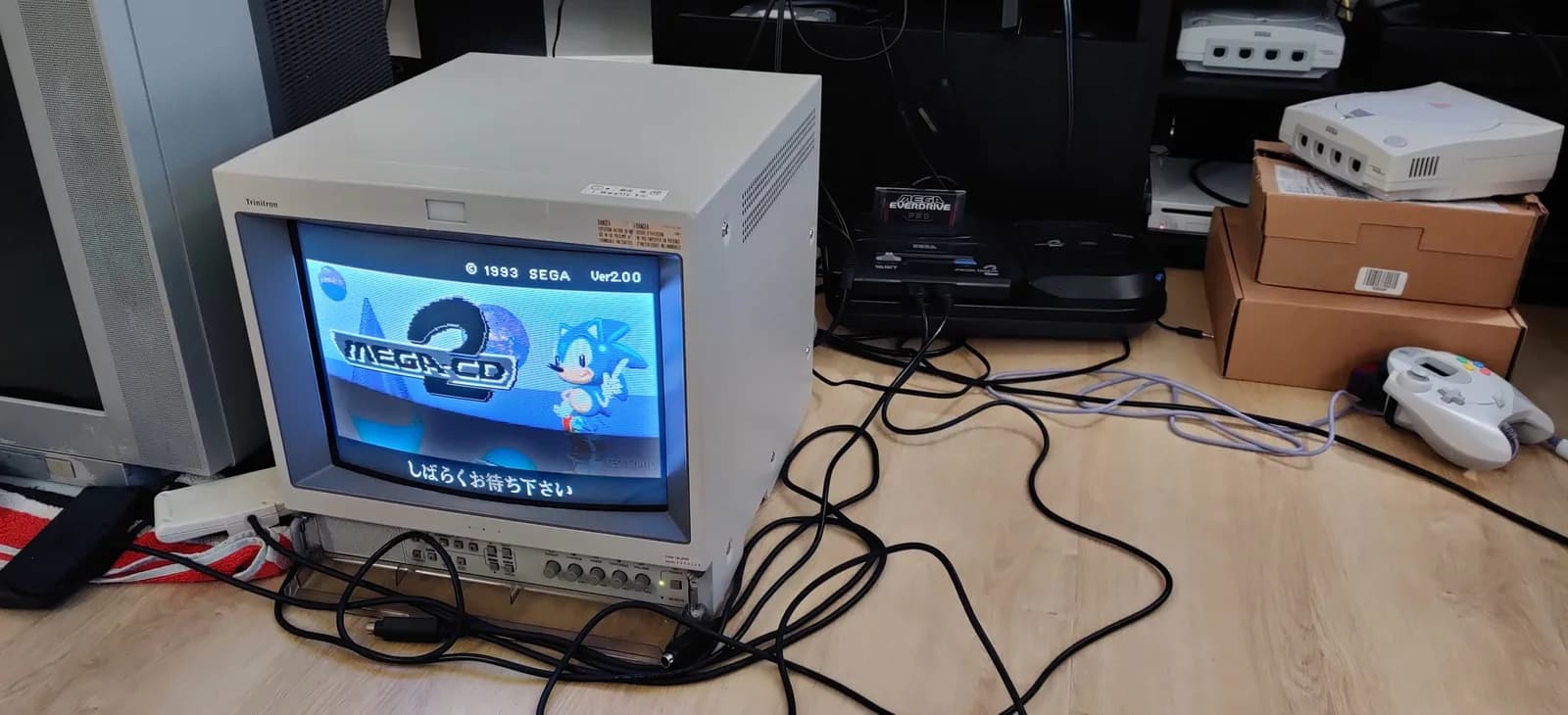 Sega Mega-CD 2 showing its BIOS boot animation, the Japanese Model 2 Mega-CD startup screen (which features Sonic), on a CRT during testing after the recap and region-free BIOS install.