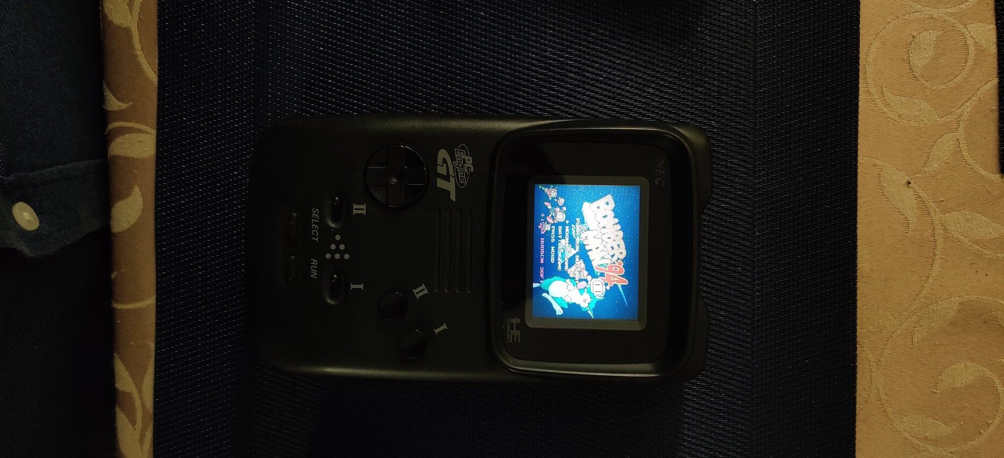 PC Engine GT handheld showing the Bomberman '94 title screen (from a Turbo Everdrive v2) after the recap and jailbar fix, a darker exposure for better contrast.