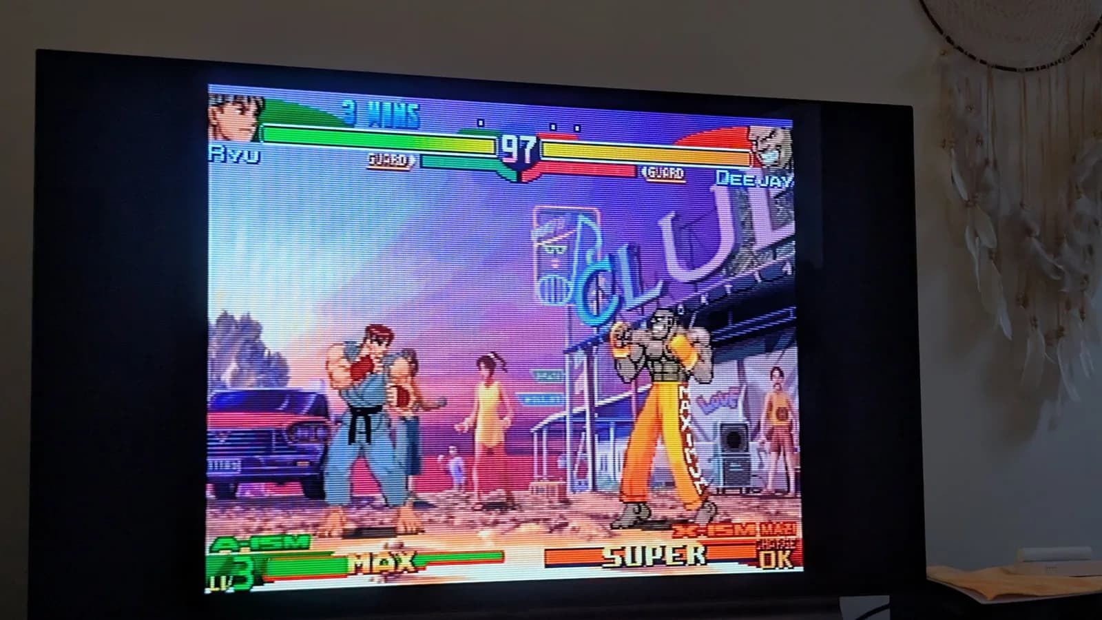 Street Fighter Alpha 3 gameplay on Dreamcast showing Ryu vs Deejay match, testing controller input after PSU recap refurbishment.