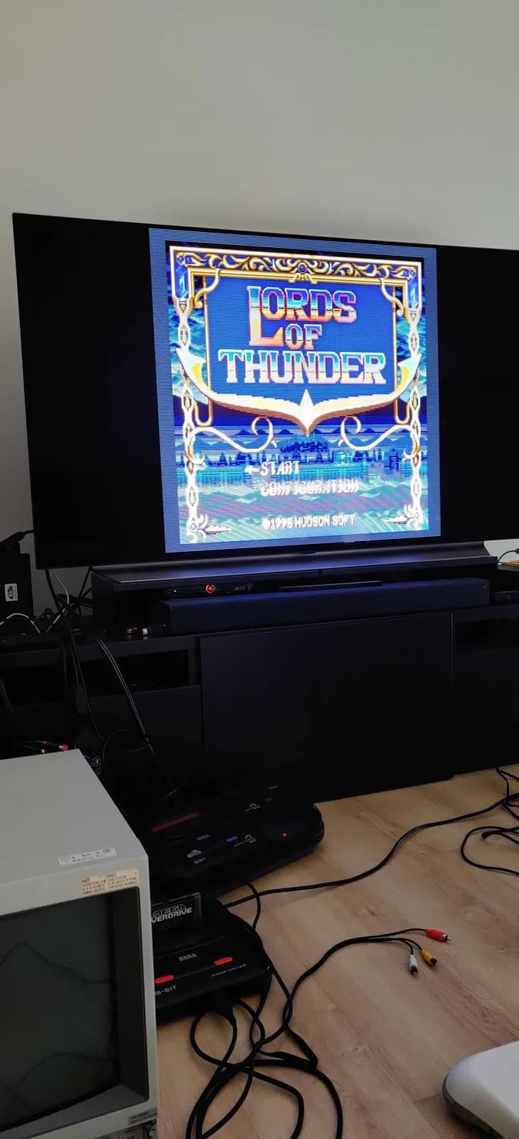 Sega Mega-CD 2 displaying Lords of Thunder title screen on CRT monitor during play test after region-free BIOS installation and recapping restoration.