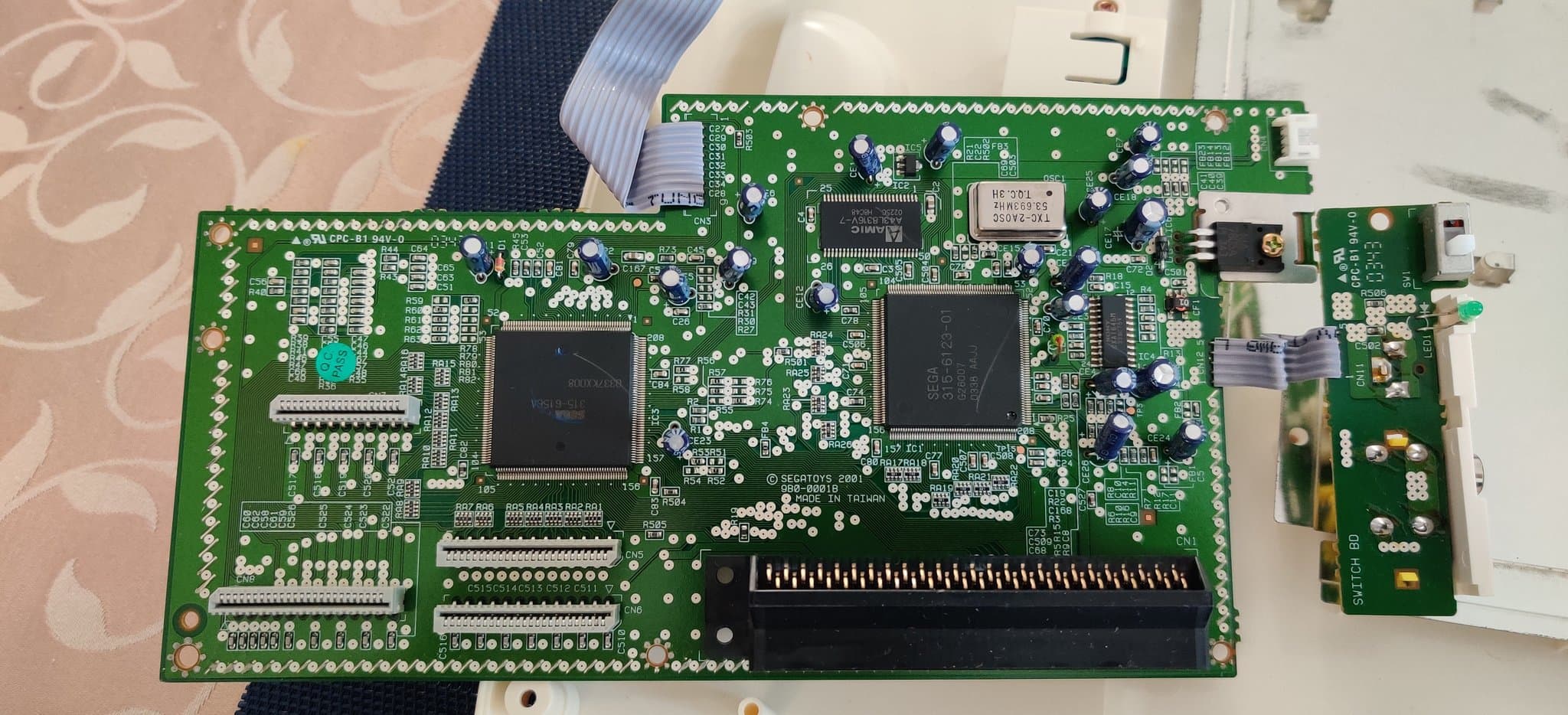 Sega Pico mainboard with new capacitors installed, voltage regulator replaced, and cleaned PCB ready for testing.