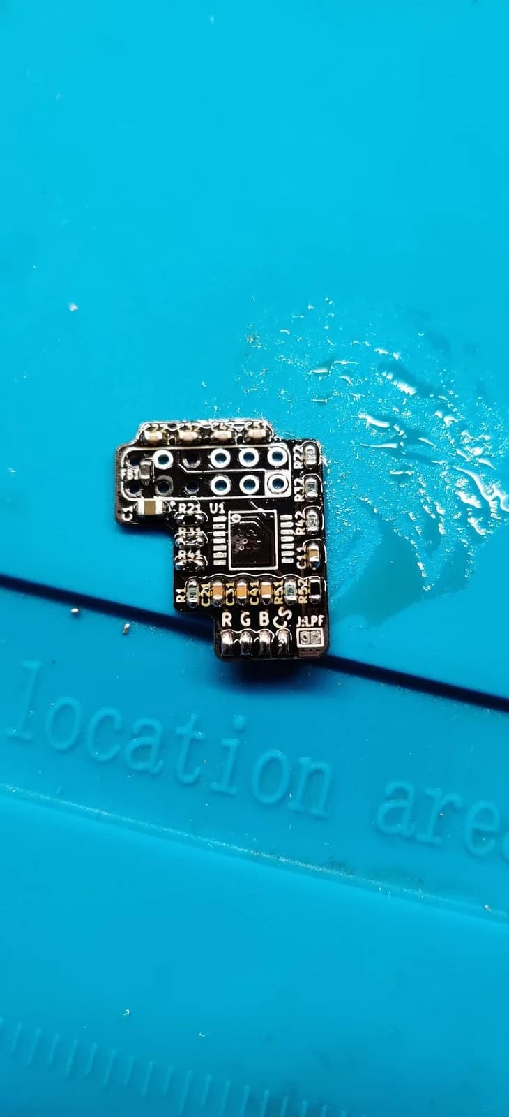 The N64 RGB amp PCB just after the hot-air reflow: the SMD components soldered down with shiny solder joints and shiny flux, the video IC not yet installed.