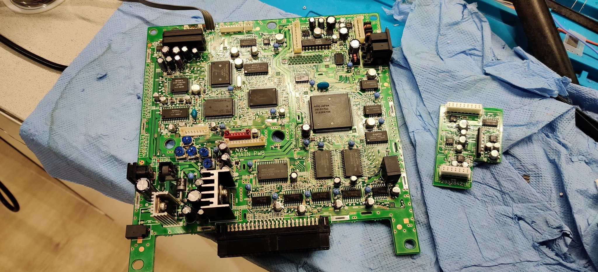 The NEC PC Engine Super CD-ROM2 mainboard and daughterboard from the previous shot, now fully recapped with new capacitors installed.