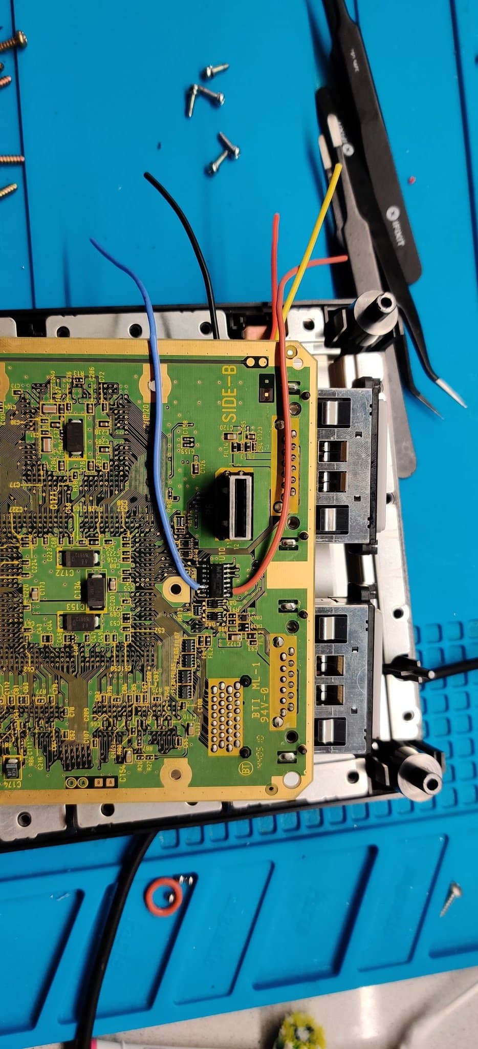 GameCube PAL DOL-101 mainboard with PicoBoot mod in progress, showing WiiKey interface, wired connections, and scattered screws on blue work mat.