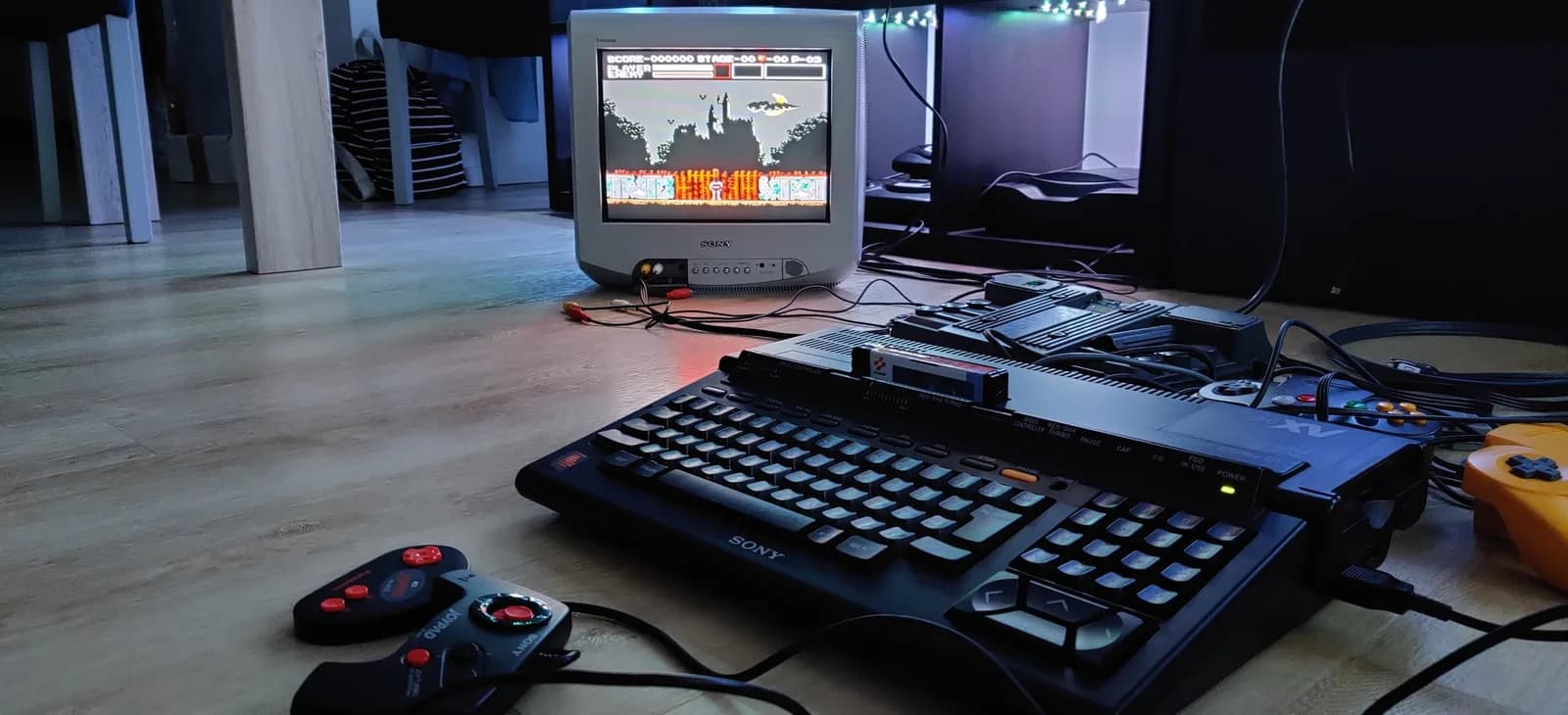 Sony HB-F1XV MSX2+ displaying retro game on CRT monitor with controller and keyboard visible on workspace during restoration project.