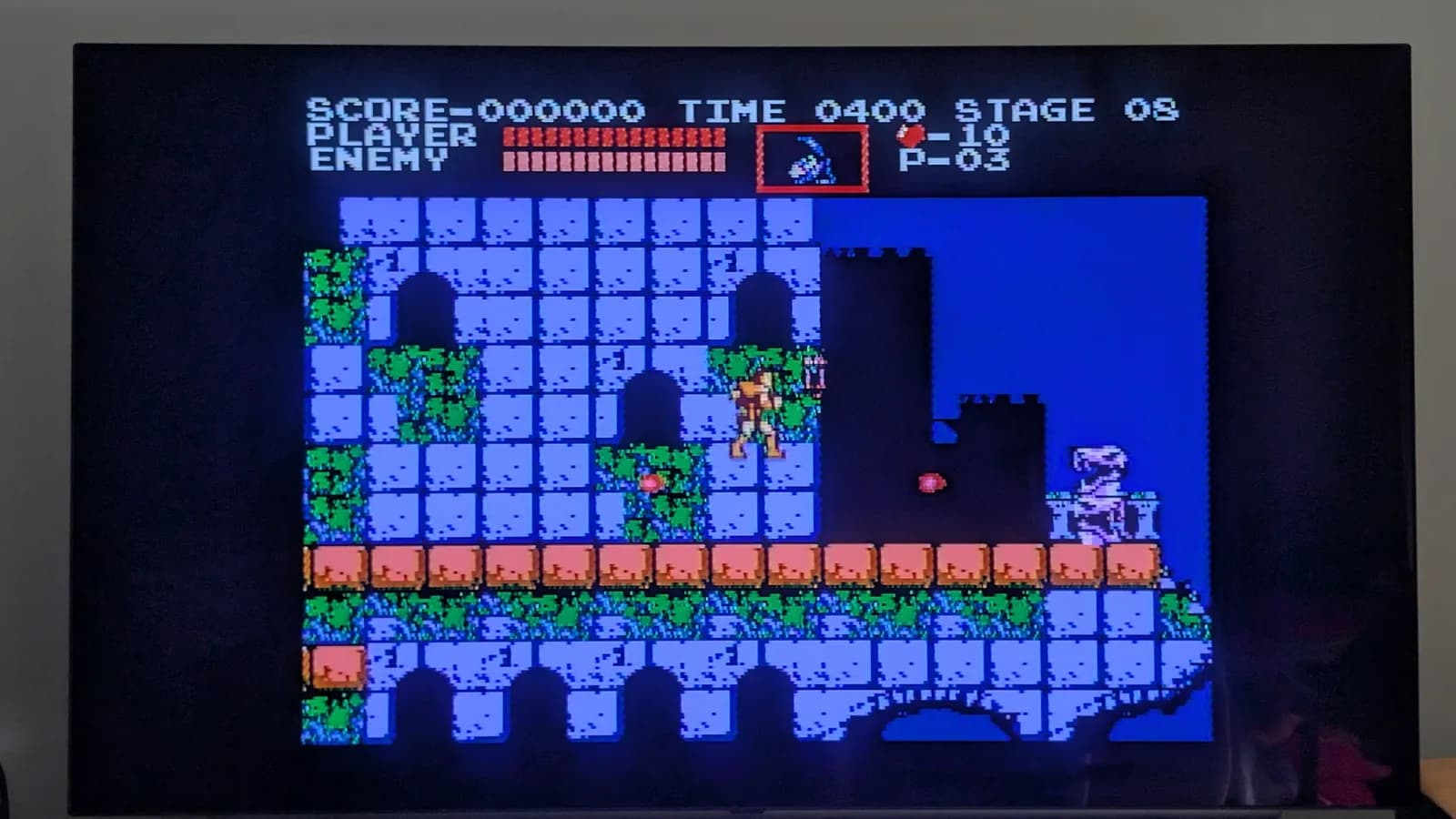 Original Castlevania (Akumajo Dracula) gameplay on an LG C1 OLED TV, output from the recapped AV Famicom. HUD reads SCORE 000000, TIME 0400, STAGE 08, with the hero on a castle-wall platform.