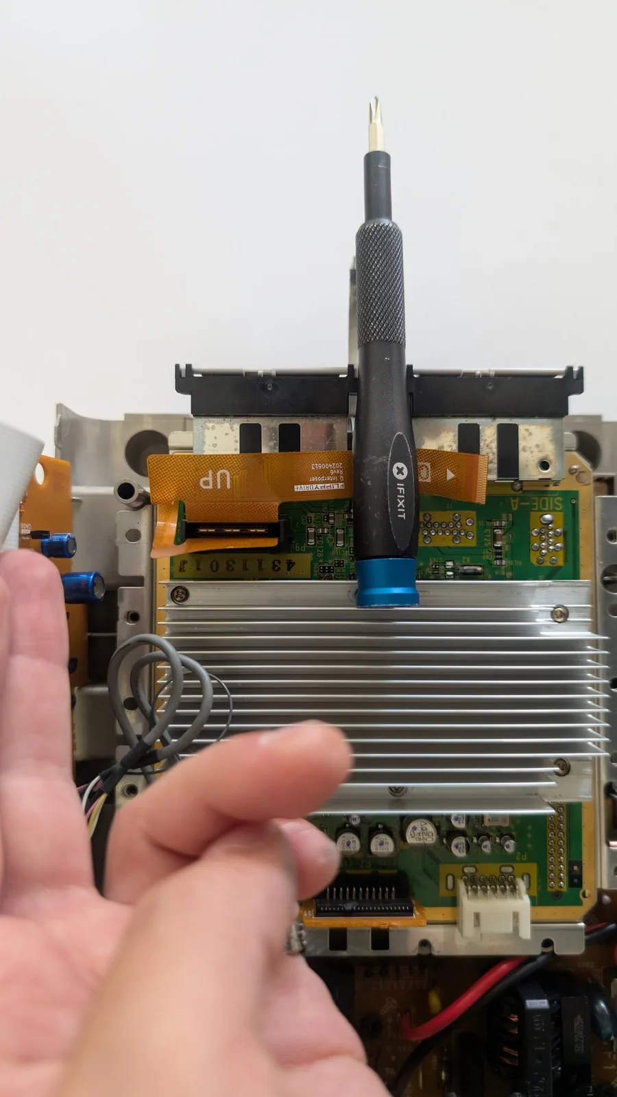 FlippyDrive installed in Panasonic Q with antenna connector visible above optical drive mechanism and circuit boards below.