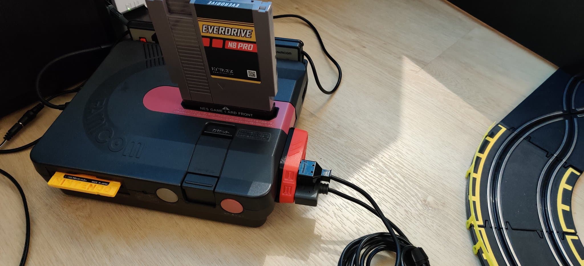 Nintendo Sharp Twin Famicom with NESRGB mod and Jeff Chen's twin diamond accessory mounted, displaying wireless controller compatibility upgrade.