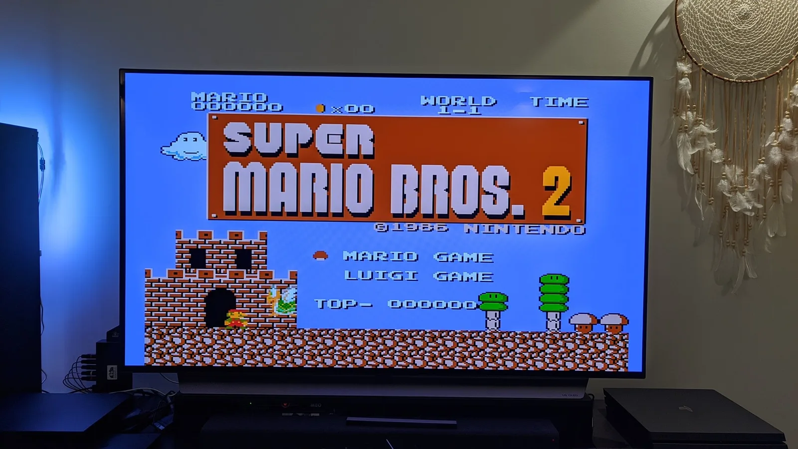 Super Mario Bros. 2 title screen (World 1-1, 1986 Nintendo) running off the NESRGB-modded Sharp Twin Famicom, shown as a clean RGB picture with no scanlines on a flat-panel TV.