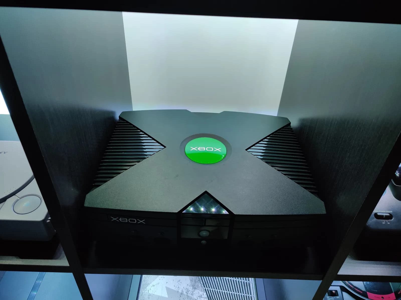 Original Xbox startup screen displaying green logo and boot animation on CRT monitor during refurbishment testing phase.