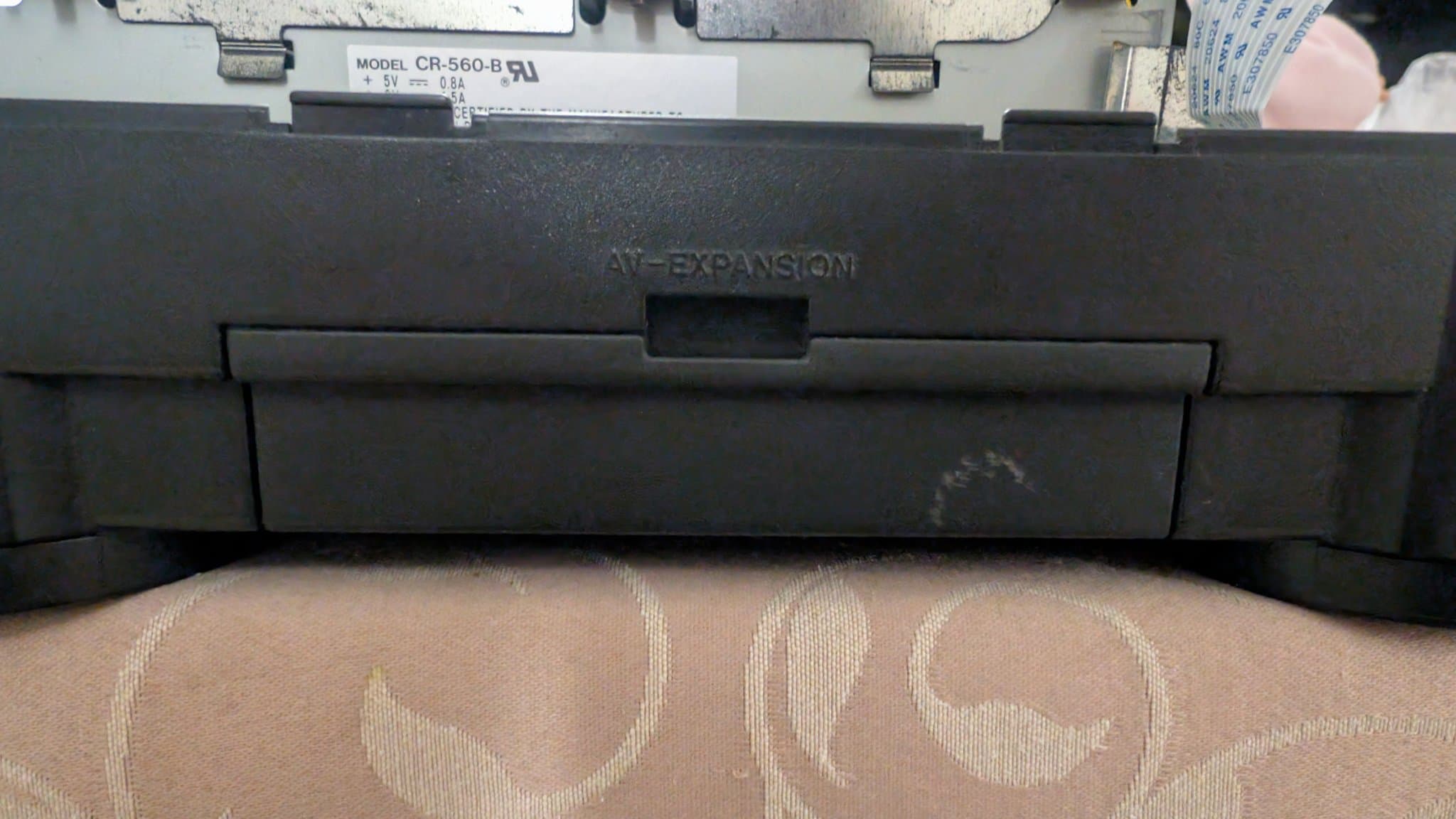 Panasonic FZ-1 3DO with AV expansion module removed, showing CB-560-B power board labeled +5V 0.6A, unit on patterned surface.