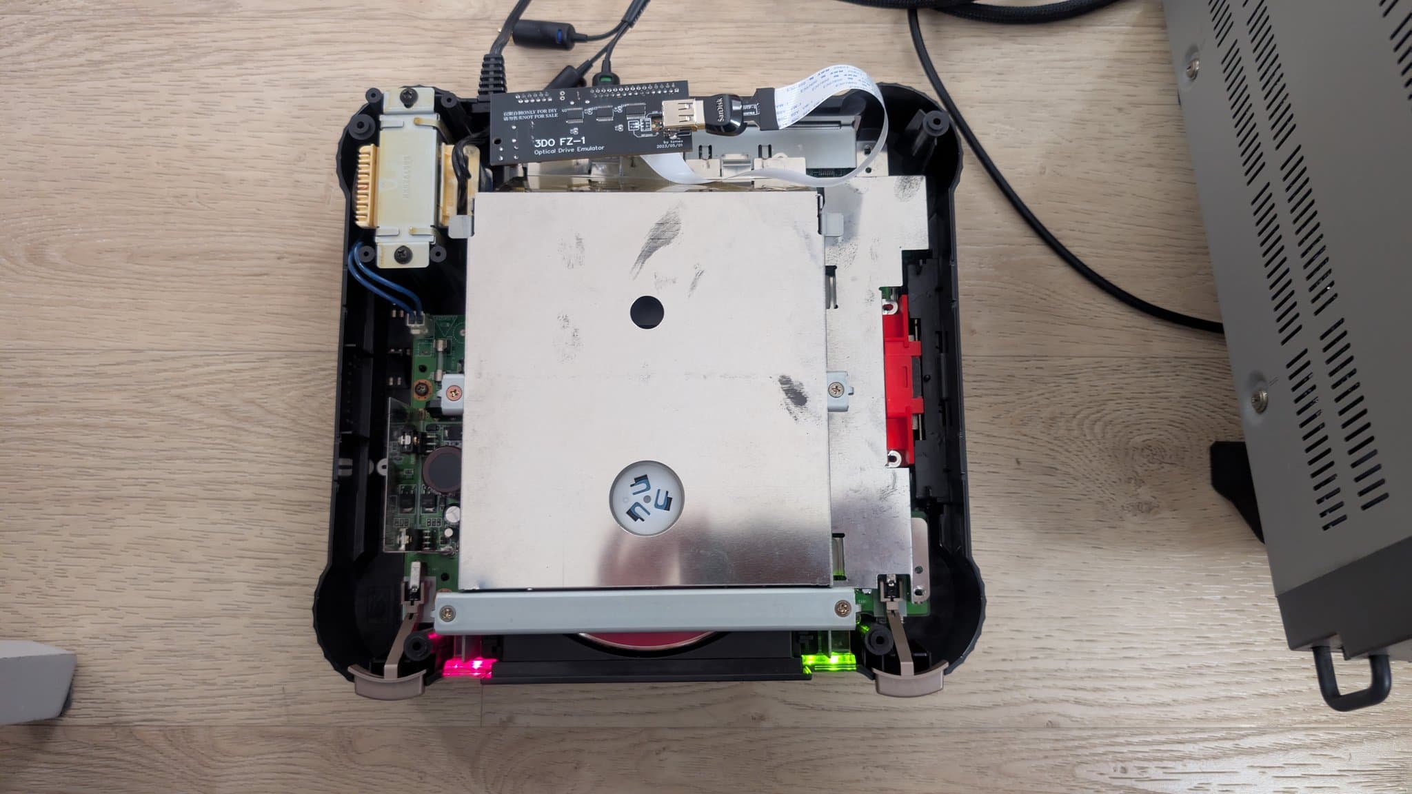 Panasonic FZ-1 internals during restoration: exposed motherboard, PSU with bridged traces, ODE installation with routed ribbon cable, LED indicators visible.