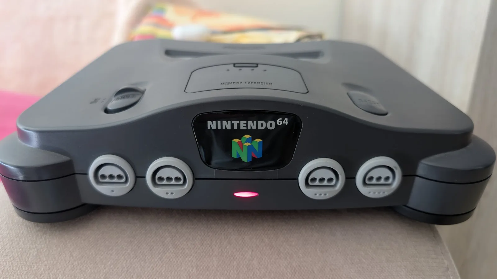 Nintendo 64 console front view showing four controller ports and power indicator light after capacitor replacement repair.