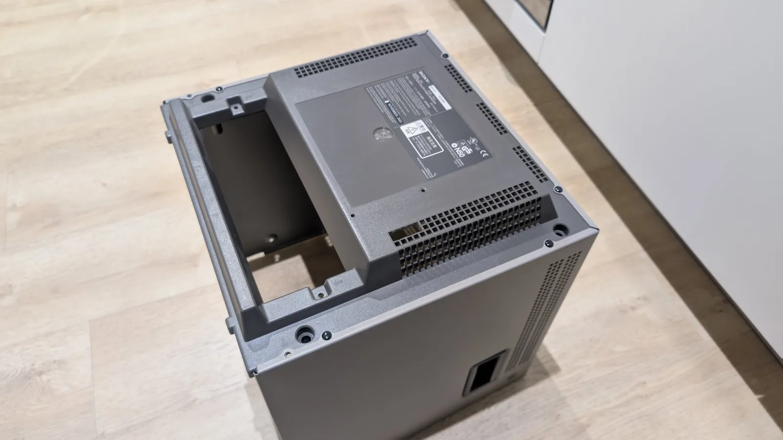Open Sony PVM-14L1 case showing installed RGB mod PCB with heatsink and internal components during assembly.