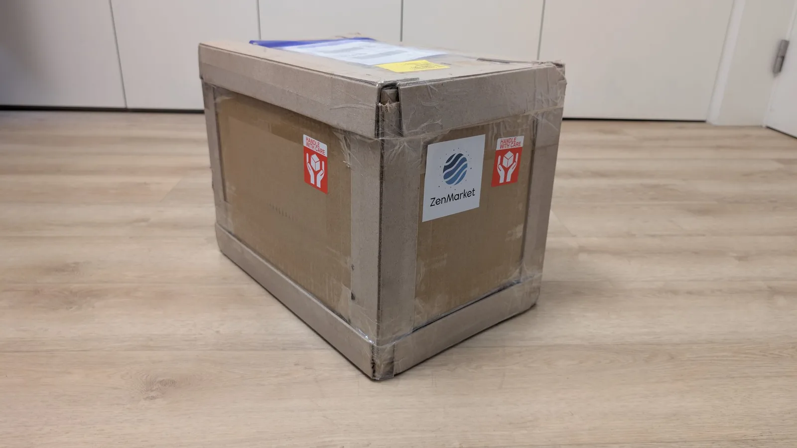 Cardboard shipping box labeled "ZenMarket" with red "Handle with Care" stickers, containing a Sony PVM-6041Q CRT monitor from Japan.