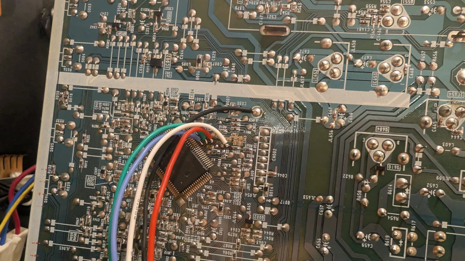 Soldering RGB mod wires (green, blue, white, red, black) onto Sony PVM-14L1 motherboard during installation of Martin Hejnfelt's RGB mod design.