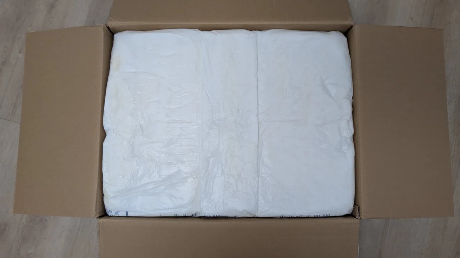 The Sharp X68000 tower still inside its shipping box, packed in white protective expandable foam.