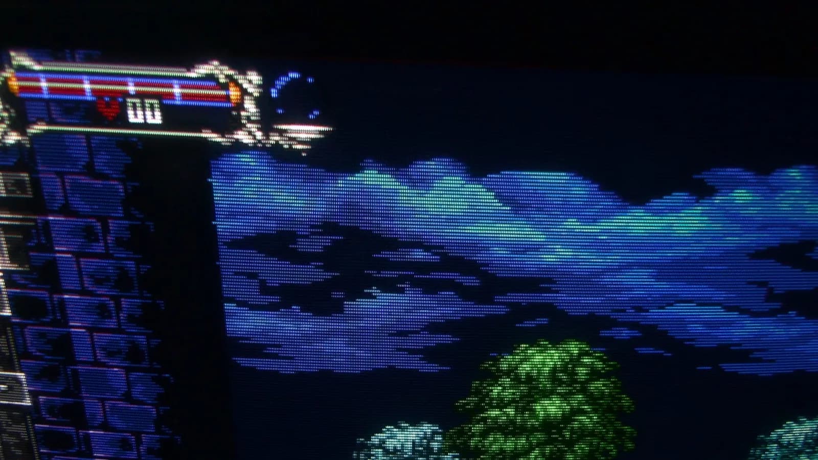 Sony PVM-9045QD showing the Mega Drive homebrew demake of Castlevania: Symphony of the Night, a close-up of the HP bar, sky, castle wall and green tree foliage.