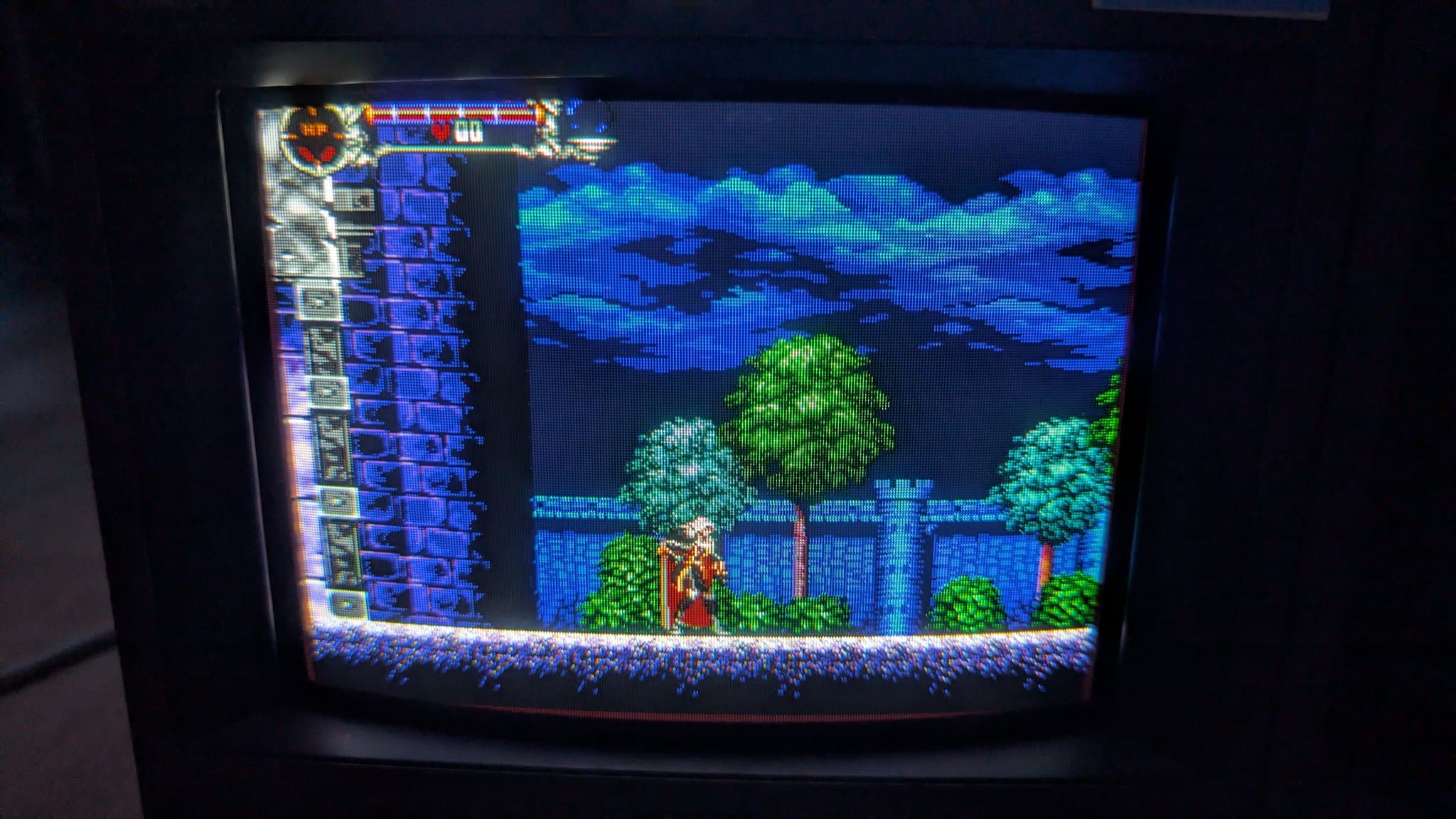 Sony PVM-9041Q displaying a classic side-scrolling game with blue sky, trees, and castle. CRT shows vibrant colors after restoration work.
