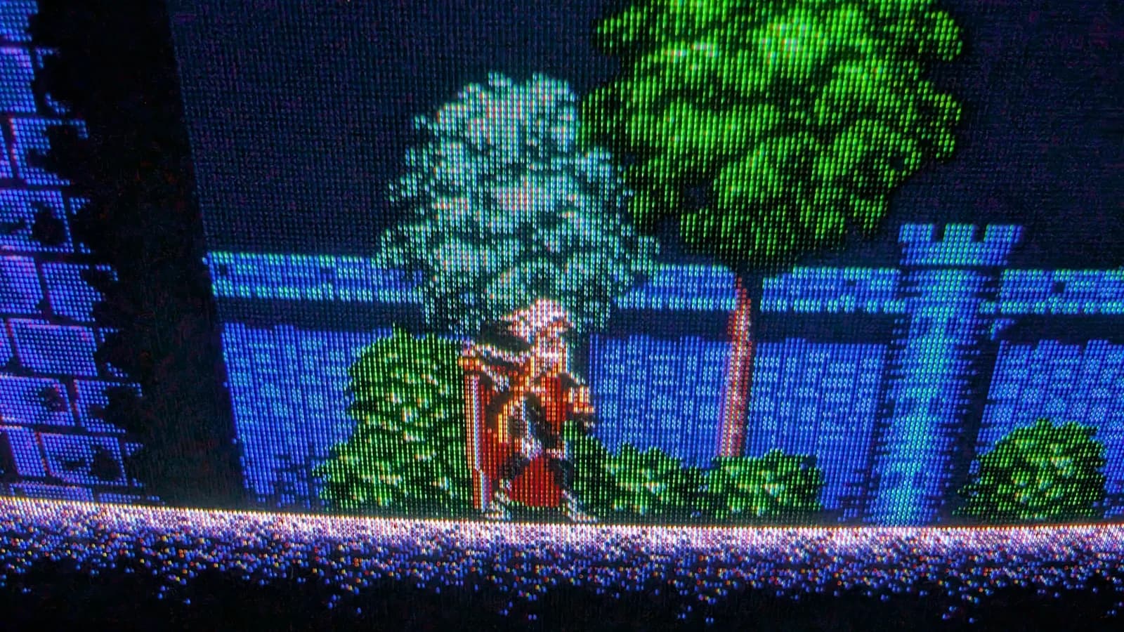Sony PVM-9041Q showing the Mega Drive homebrew demake of Castlevania: Symphony of the Night, a closer view of Alucard (his red cape) before the blue castle wall with trees and foliage.