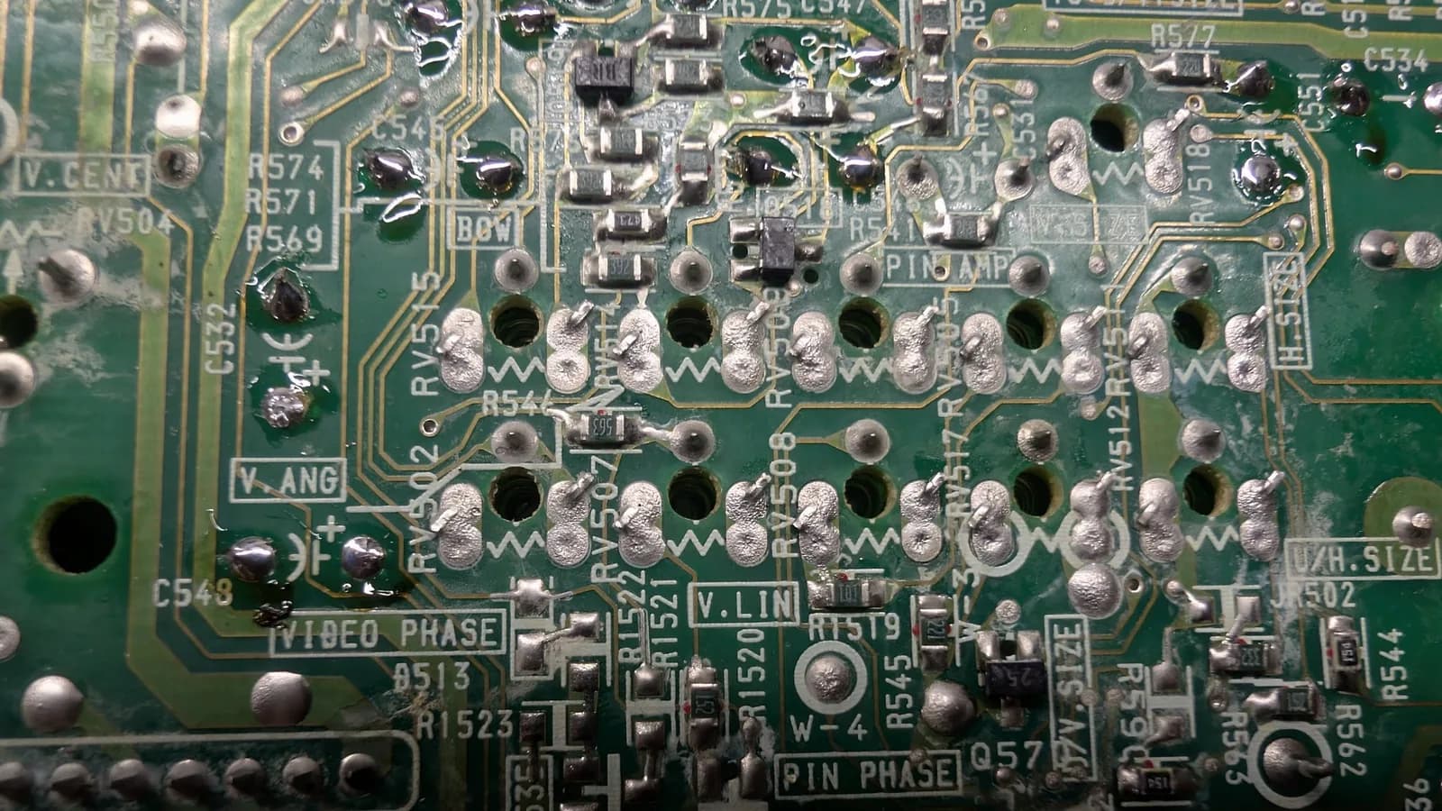 The same mid-reflow close-up for the Sony PVM-9041Q deflection board, a mix of freshly reflowed shiny joints and grainy old ones still to be redone.