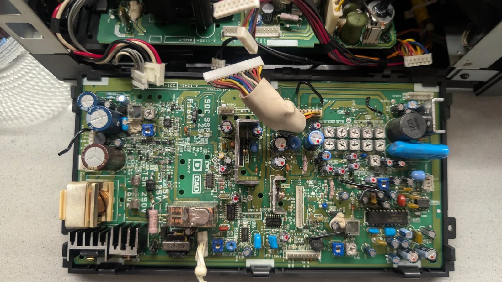 The same Sony PVM-9041Q deflection board from the top, every replaced capacitor marked with a red dot.