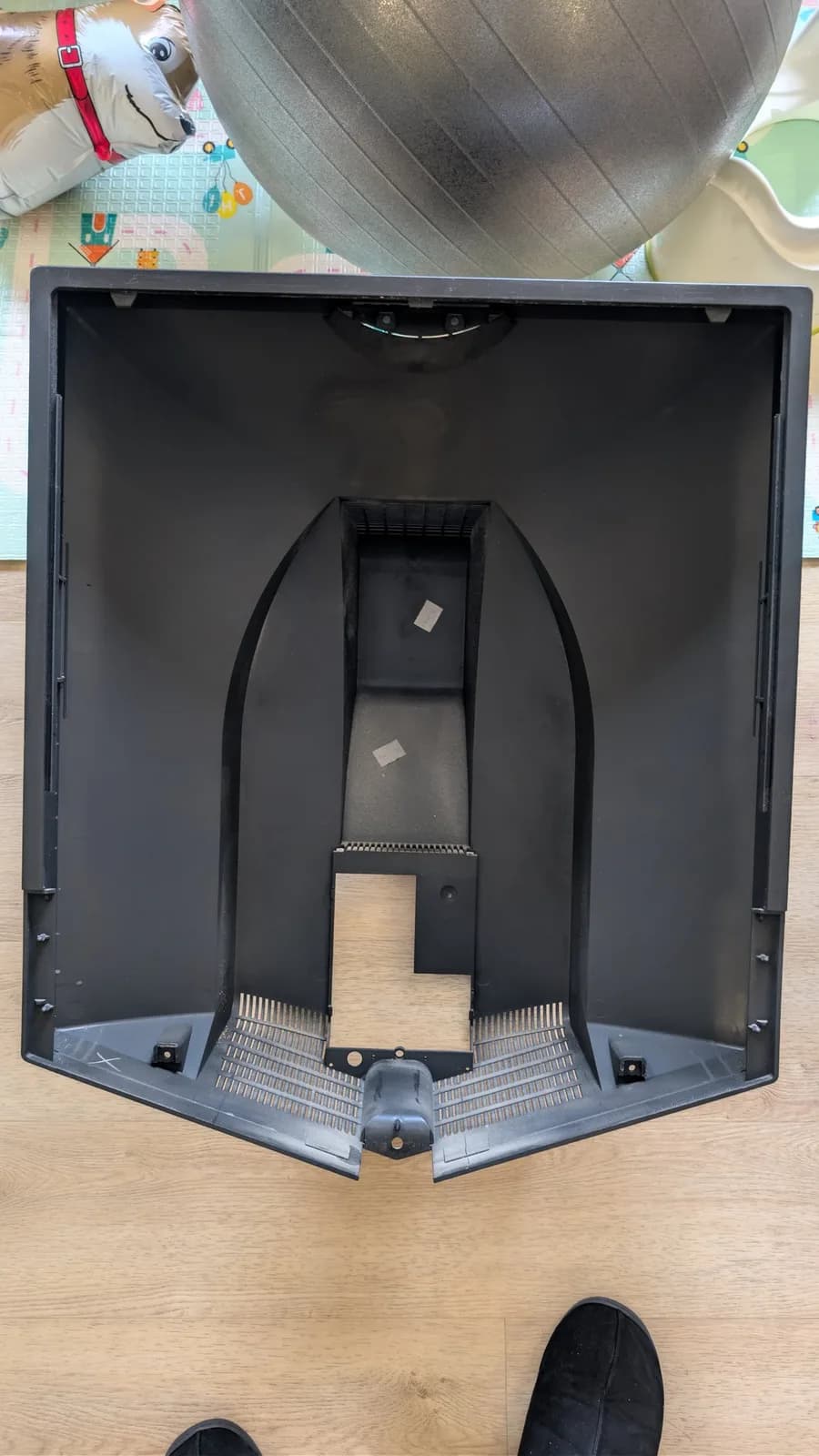 Interior view of B&O Beovision 1 showing back panel removed, exposing black metal chassis with wooden support block and internal components visible from above.