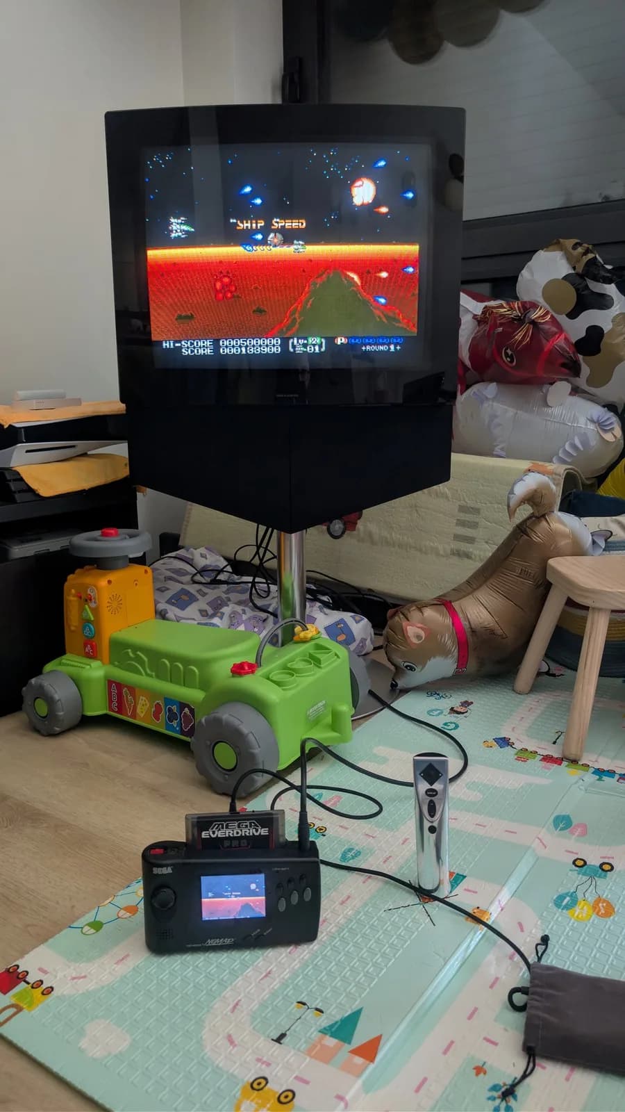 Beovision 1 CRT displaying arcade game with Sega Mega Drive controller below; new KEMET safety cap installed post-repair.