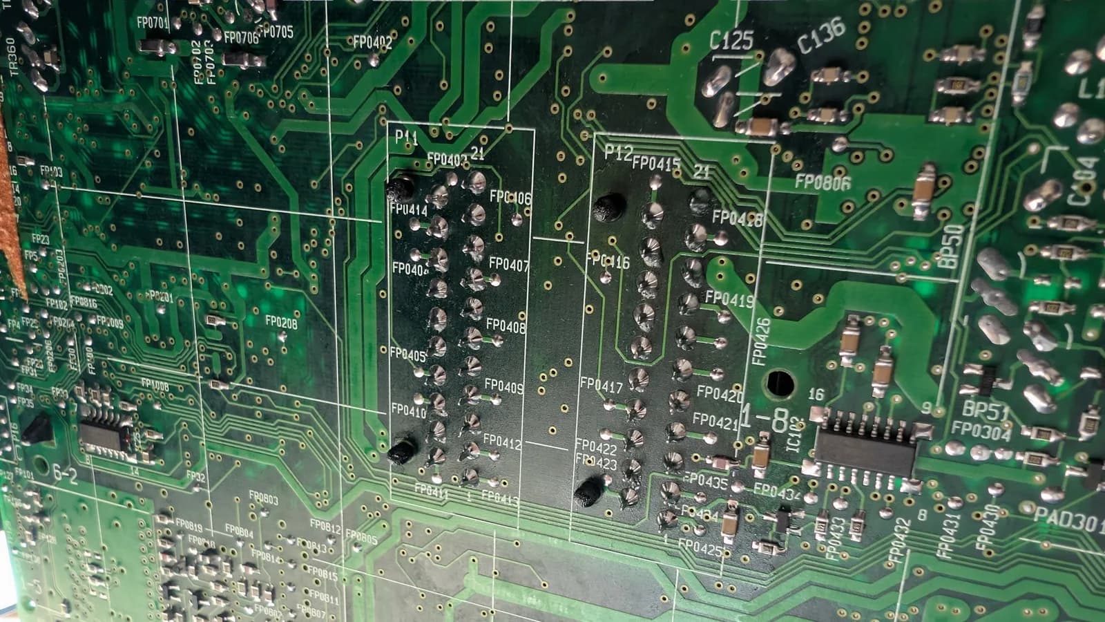 Close-up of B&O Beovision 1 PCB showing reflowed SCART port solder joints and surrounding capacitors labeled FP0403-FP0435.