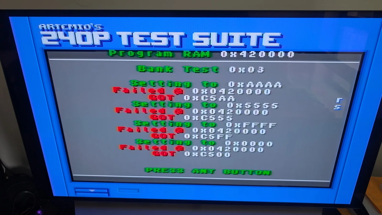 Artemia's 240P Test Suite showing Program RAM 0x420000 and Bank Test failures in red text with memory address codes displayed.