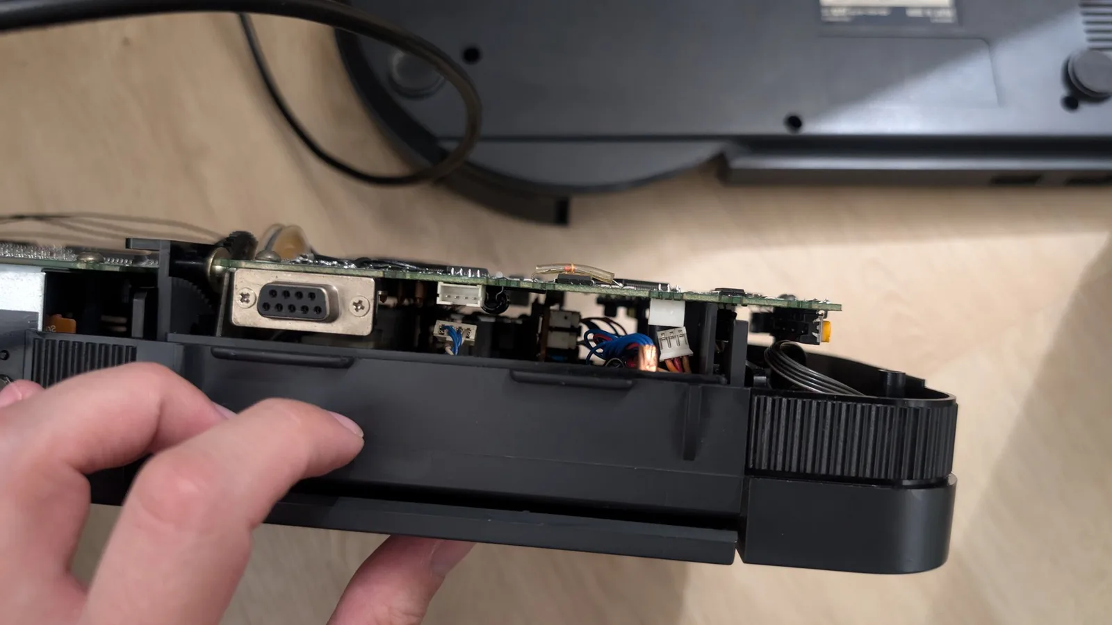 Wondermega optical drive assembly with disconnected cables; internal circuitry, connectors, and motor mechanism visible during troubleshooting.