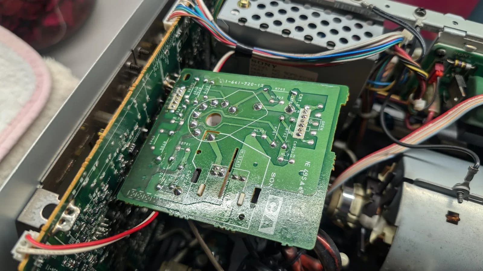 The Sony PVM-9045QD's CRT neck/video-drive board (Sony 1-641-720-13) from the solder side, reflowed, the metal-cased Sony PSU module alongside it in the case.